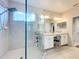 Modern bathroom with a double vanity, large shower, and elegant finishes at 172 Seville Dr, Davenport, FL 33837