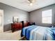 Gray bedroom with bed and dresser at 172 Seville Dr, Davenport, FL 33837