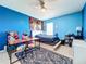 Blue bedroom with bed, desk, and dresser at 172 Seville Dr, Davenport, FL 33837