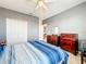 Gray bedroom with bed, dresser, and access to another room at 172 Seville Dr, Davenport, FL 33837