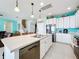 Well-equipped kitchen featuring an island, stainless steel appliances, and white cabinets at 172 Seville Dr, Davenport, FL 33837