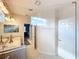 Spa-like bathroom with a large glass shower, double vanity, and natural light at 172 Seville Dr, Davenport, FL 33837