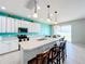 Spacious kitchen boasts an island, stainless steel appliances, and white cabinetry at 172 Seville Dr, Davenport, FL 33837