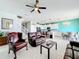 Cozy living room featuring leather furniture and a view into the kitchen and dining area at 172 Seville Dr, Davenport, FL 33837