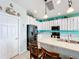 Modern kitchen with white cabinets, stainless steel appliances, and an island at 172 Seville Dr, Davenport, FL 33837