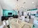 Open concept kitchen and dining area with stainless steel appliances and a spacious island at 172 Seville Dr, Davenport, FL 33837