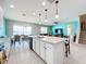 Open concept kitchen with island, stainless steel appliances, and view to living room at 172 Seville Dr, Davenport, FL 33837