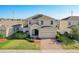 Two-story house with solar panels, two-car garage, and well-maintained lawn at 172 Seville Dr, Davenport, FL 33837