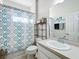 Clean bathroom with shower/tub combo, vanity, and patterned shower curtain at 172 Seville Dr, Davenport, FL 33837