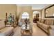 Living room with beige sofas, coffee table, and decorative accents at 13144 Coldwater Loop, Clermont, FL 34711