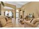 Living room with beige sofas, coffee table, and decorative accents at 13144 Coldwater Loop, Clermont, FL 34711