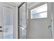 Shower with sliding glass doors and a window for natural light at 13144 Coldwater Loop, Clermont, FL 34711