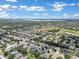Aerial view of a residential community near a lake and golf course at 13144 Coldwater Loop, Clermont, FL 34711
