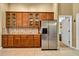 Kitchen features wood cabinets with glass doors, granite countertops, and stainless steel appliances at 13144 Coldwater Loop, Clermont, FL 34711