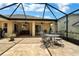 Spacious screened-in patio with a table and chairs at 13144 Coldwater Loop, Clermont, FL 34711
