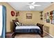 Well-decorated bedroom with a full-sized bed and unique wall decor at 13144 Coldwater Loop, Clermont, FL 34711