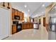 Kitchen features wood cabinets, granite countertops, and stainless steel appliances at 13144 Coldwater Loop, Clermont, FL 34711