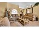 Living room with beige sofas, coffee table, and decorative accents at 13144 Coldwater Loop, Clermont, FL 34711