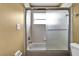 Clean bathroom with a shower/tub combo and frosted glass door at 13144 Coldwater Loop, Clermont, FL 34711