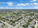 Aerial view of a residential area featuring houses, golf course, and a lake at 13144 Coldwater Loop, Clermont, FL 34711