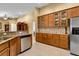 Kitchen features wood cabinets with glass doors, granite countertops, and stainless steel appliances at 13144 Coldwater Loop, Clermont, FL 34711