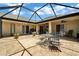 Spacious screened-in patio with a table and chairs at 13144 Coldwater Loop, Clermont, FL 34711