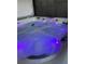 Hot tub with LED lighting and waterfall feature at 316 Blue Cypress Dr, Groveland, FL 34736