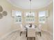 Charming dining area with a round table and chairs, surrounded by windows at 6514 Crews Lake Crest Loop, Lakeland, FL 33813