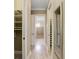 Bright hallway with built-in storage and wood-look flooring at 6514 Crews Lake Crest Loop, Lakeland, FL 33813