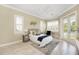 Spacious bedroom with large windows, hardwood floors, and access to a private balcony at 6514 Crews Lake Crest Loop, Lakeland, FL 33813