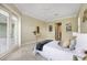 Large bedroom with king bed, hardwood floors, and access to a private patio at 6514 Crews Lake Crest Loop, Lakeland, FL 33813