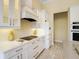 Modern kitchen with white cabinets, quartz countertops, and stainless steel appliances at 6514 Crews Lake Crest Loop, Lakeland, FL 33813