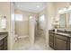 Bathroom with walk-in shower, double vanity, and modern finishes at 6514 Crews Lake Crest Loop, Lakeland, FL 33813