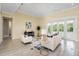 Living room with hardwood floors, white couch and access to backyard at 6514 Crews Lake Crest Loop, Lakeland, FL 33813