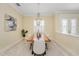 Formal dining area with wood table, chandelier, and view to entryway at 6514 Crews Lake Crest Loop, Lakeland, FL 33813