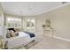Elegant Primary bedroom with a king-size bed, hardwood floors, and access to a private patio at 6514 Crews Lake Crest Loop, Lakeland, FL 33813