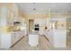 Spacious kitchen featuring a large island, white cabinetry, and updated flooring at 6514 Crews Lake Crest Loop, Lakeland, FL 33813
