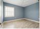 Light blue bedroom with wood-look flooring and window shutters at 6514 Crews Lake Crest Loop, Lakeland, FL 33813