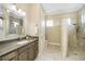 Spa-like bathroom with large walk-in shower, double vanity, and plenty of storage at 6514 Crews Lake Crest Loop, Lakeland, FL 33813