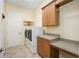 Laundry room with built-in cabinets and workspace at 6514 Crews Lake Crest Loop, Lakeland, FL 33813