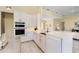 Bright kitchen with white cabinets, double oven, and large kitchen island at 6514 Crews Lake Crest Loop, Lakeland, FL 33813