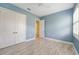 Blue bedroom with white doors and wood flooring at 6514 Crews Lake Crest Loop, Lakeland, FL 33813