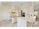 Modern white kitchen with center island and stainless steel appliances at 6514 Crews Lake Crest Loop, Lakeland, FL 33813