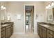 Double vanity bathroom with a view into a bedroom and access to a large walk-in shower at 6514 Crews Lake Crest Loop, Lakeland, FL 33813