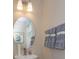Clean bathroom with oval mirror, sink and towel rack at 13249 Peaceful Melody Dr, Winter Garden, FL 34787
