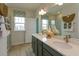 Double vanity bathroom with modern fixtures and a large mirror at 13249 Peaceful Melody Dr, Winter Garden, FL 34787