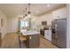 Modern kitchen with white cabinets, stainless steel appliances, and an island at 13249 Peaceful Melody Dr, Winter Garden, FL 34787