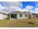 View of the back of the house and yard at 1586 Outback Rd, Saint Cloud, FL 34771