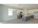 Modern kitchen with gray island, white cabinets and breakfast nook at 1586 Outback Rd, Saint Cloud, FL 34771