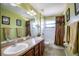 Main bathroom with double vanity, bathtub, and shower at 3011 Indian Trl, Eustis, FL 32726